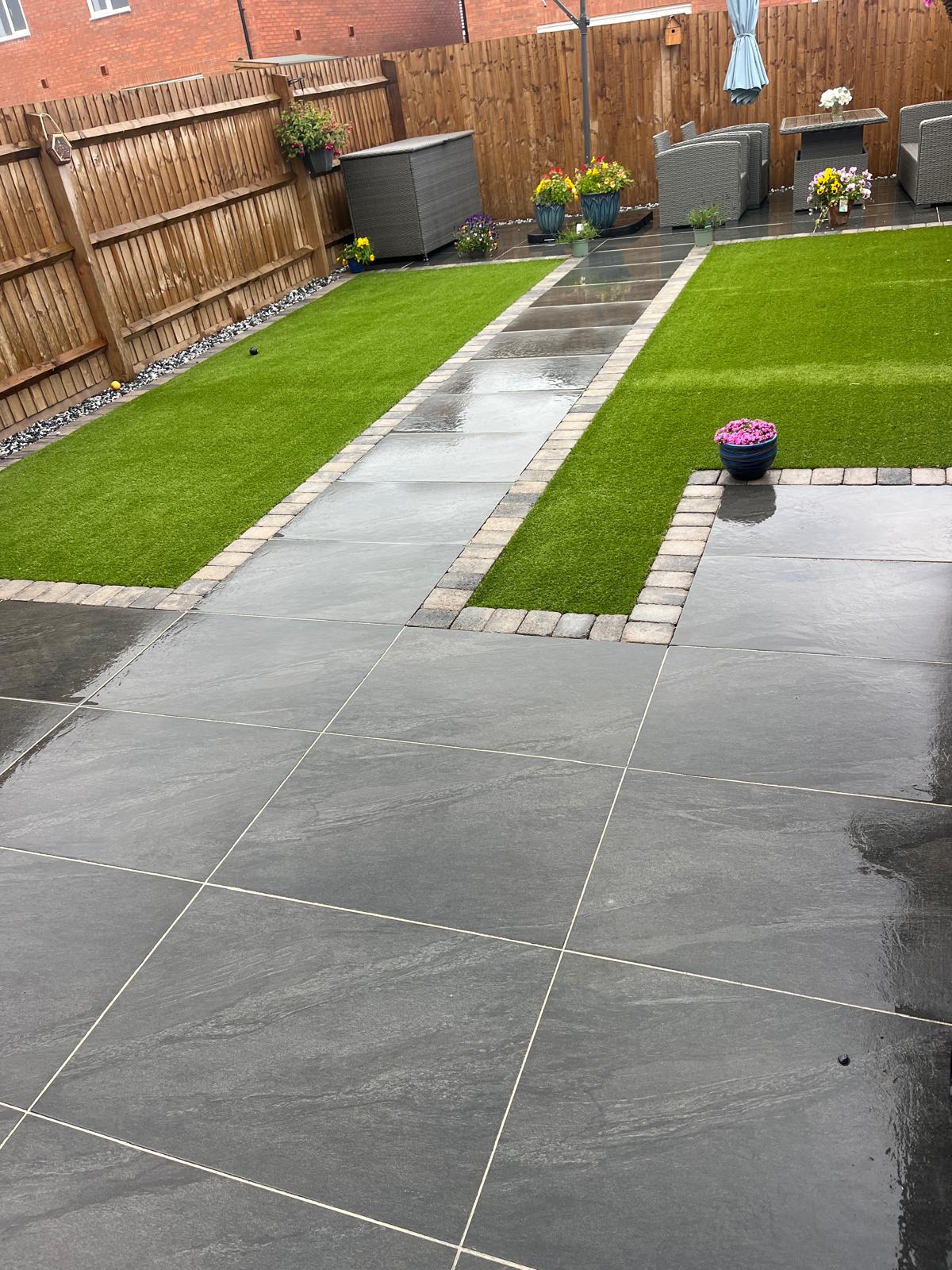Finished garden with lawn, stone paths and a spacious dark patio